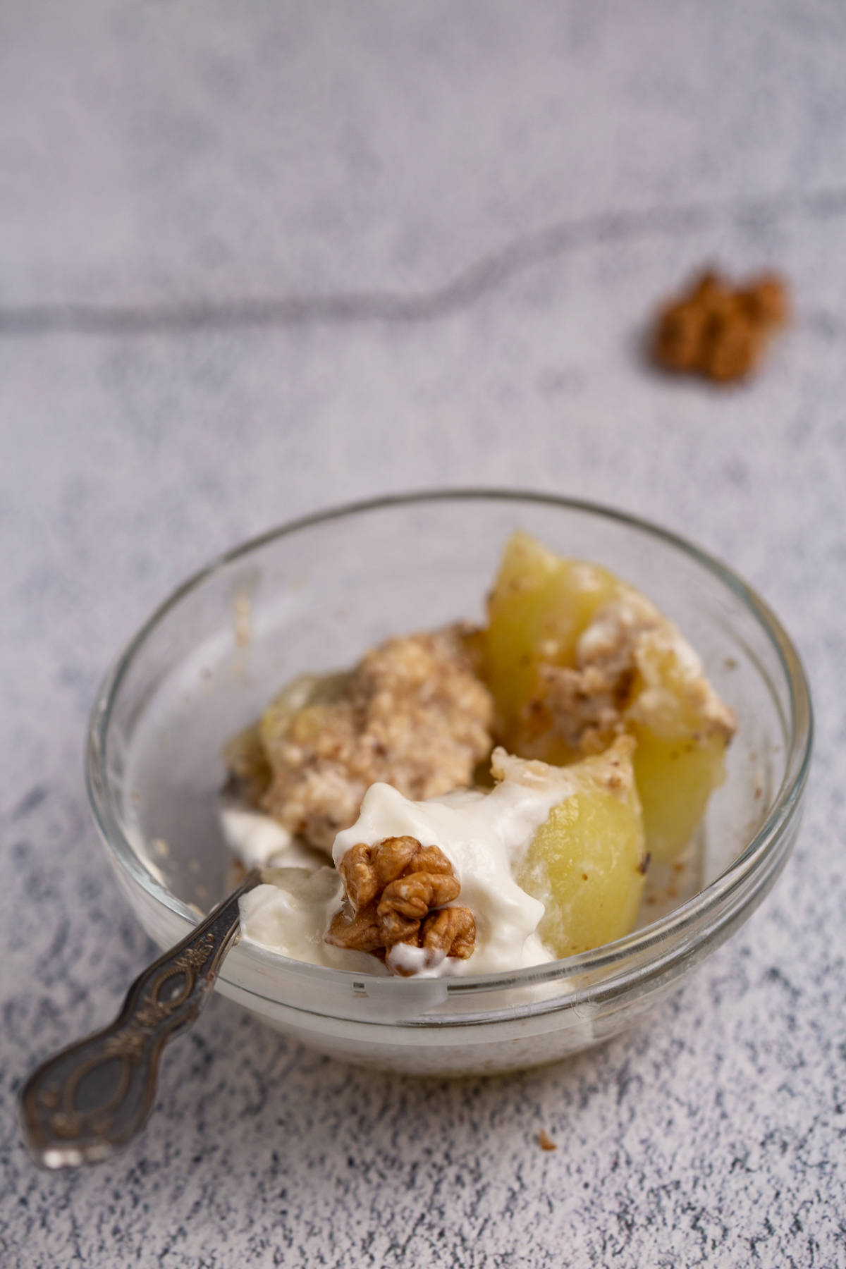 Dessert in a glass bowl with a spoon. 